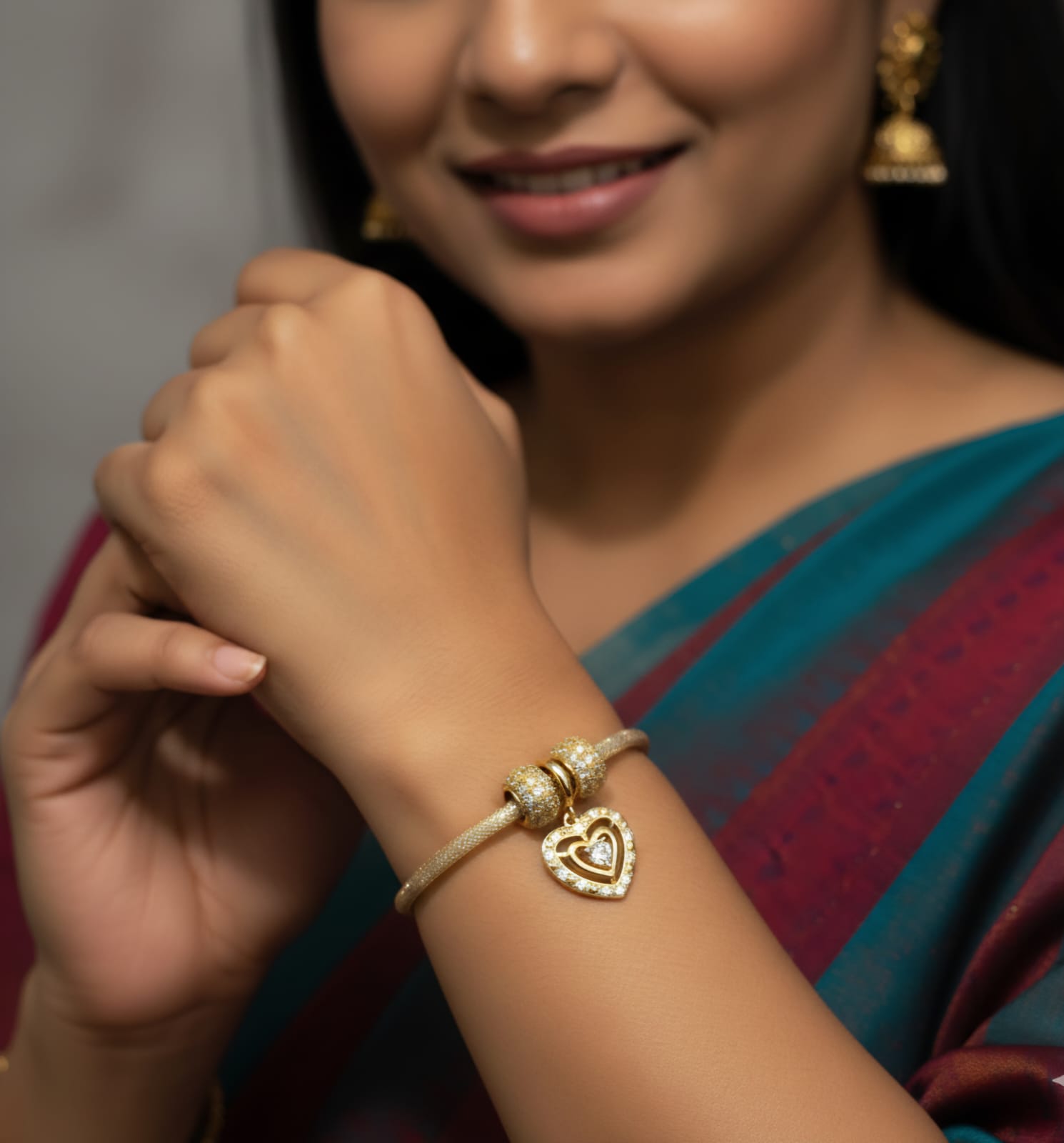 Stylish dual-tone beaded bracelet featuring glossy silver and white pearl beads with tiny golden spacers and a sparkling heart-shaped charm, perfect for partywear and daily fashion