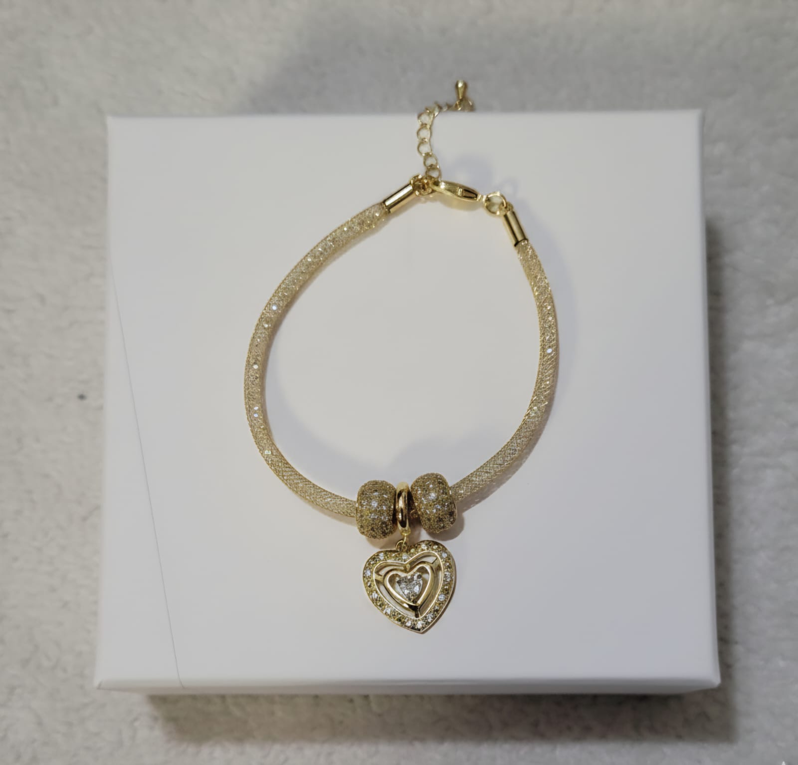 Stylish dual-tone beaded bracelet featuring glossy silver and white pearl beads with tiny golden spacers and a sparkling heart-shaped charm, perfect for partywear and daily fashion